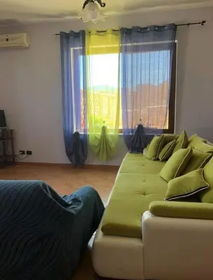 two chairs and a coffee table on a patio at appartamento in villa splendente in Castellammare del Golfo