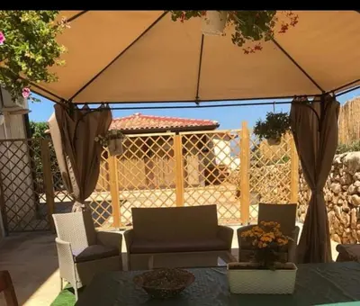 a bedroom with a green bed with towels on it at appartamento in villa splendente in Castellammare del Golfo