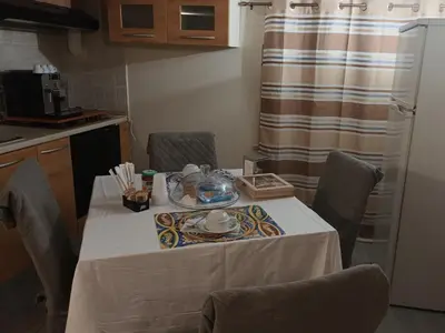 a table in a kitchen with a white table cloth at Casa TerraMare in Palermo