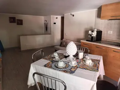 a kitchen with a table with a white table cloth at Casa TerraMare in Palermo