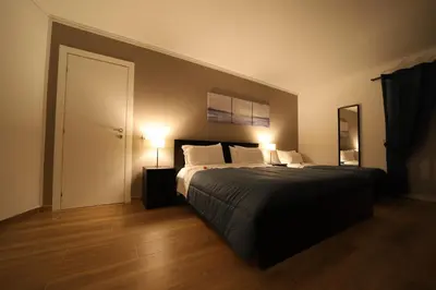 a bedroom with a large bed with two lamps at Boscò Suites in Carini