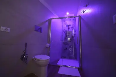 a purple bathroom with a toilet and a shower at Boscò Suites in Carini