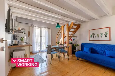 a living room with a blue couch and a table at Sant'Onofrio Apartments by Wonderful Italy in Palermo