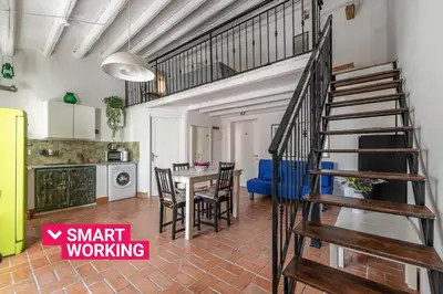 a kitchen and dining room with a spiral staircase in a apartment at Sant'Onofrio Apartments by Wonderful Italy in Palermo