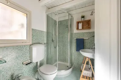 a bathroom with a shower and a toilet and a sink at Sant'Onofrio Apartments by Wonderful Italy in Palermo