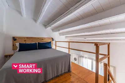 a bedroom with a bed with a sign on it at Sant'Onofrio Apartments by Wonderful Italy in Palermo