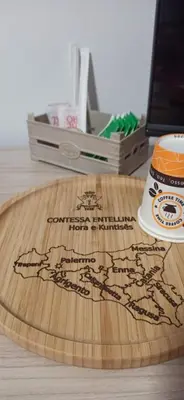 a wooden board with a map on it on a desk at Contessa Vacanze Byron in Contessa Entellina