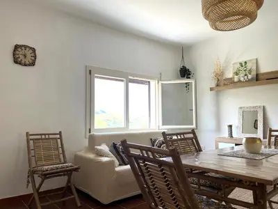 a dining room with a table and a couch at Villetta con Oliveto CFG in Prizzi