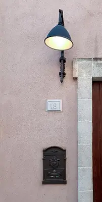 a light on the side of a building with a door at Casa all'Annunziata in Termini Imerese