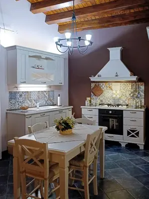 a kitchen with a table with chairs and a stove at Casa all'Annunziata in Termini Imerese