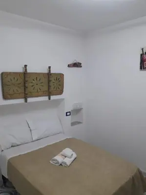 a bedroom with a bed with two towels on it at Oneto Apartment in Palermo