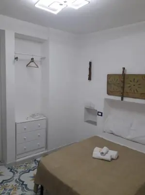 a bedroom with a bed with two towels on it at Oneto Apartment in Palermo