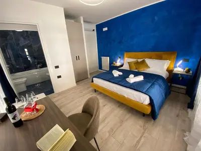 a hotel room with a bed and a dining table at Hotel Plaza Ungheria in Palermo
