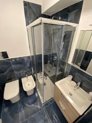 a bathroom with two sinks and two toilets at Hotel Plaza Ungheria in Palermo