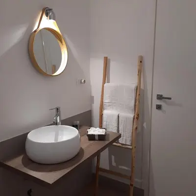 a bathroom with a white sink and a mirror at Quattrocantiapartments in Palermo