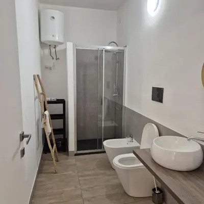 a bathroom with a toilet and a sink and a shower at Quattrocantiapartments in Palermo