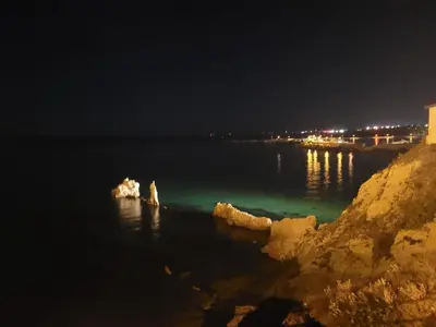 a view of a body of water at night at Casa Makira in Terrasini