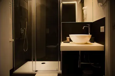 a bathroom with a glass shower and a sink at Nostrale bnb in Palermo