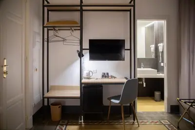 a room with a desk with a monitor and a chair at Nostrale bnb in Palermo