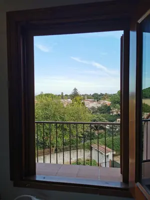a window with a view of a balcony at Villa Iris - Mondello in Palermo