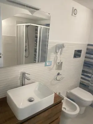 a bathroom with a sink and a toilet and a mirror at appartamento francy solare in Castellammare del Golfo