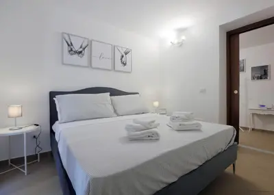 a bedroom with a bed with towels on it at Bonello House Cattedrale in Palermo