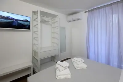 a white room with a table with two towels at Bonello House Cattedrale in Palermo