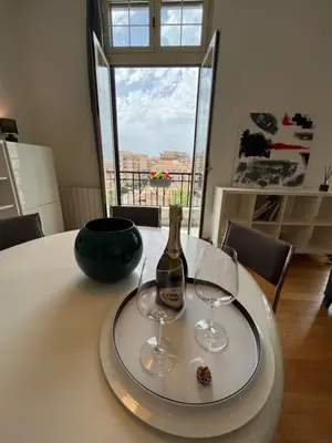 a bottle of champagne and two wine glasses on a table at POLITEAMA SUITE IN THE HEART OF THE CITY in Palermo