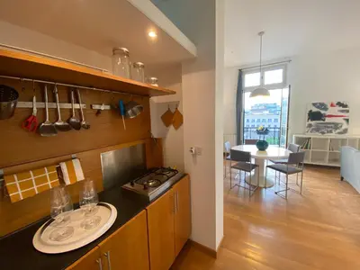 a kitchen with a stove and a dining room at POLITEAMA SUITE IN THE HEART OF THE CITY in Palermo
