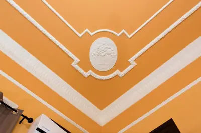 a room with orange walls and a white ceiling at Bohème B&B in Palermo