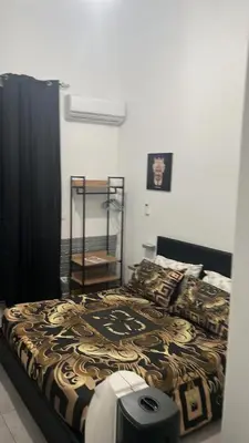 a bedroom with a bed with a black and gold blanket at La Casa di Bella in Palermo