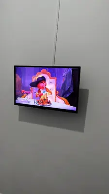 a flat screen tv hanging on a white wall at La Casa di Bella in Palermo