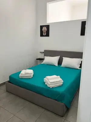 a bedroom with a bed with towels on it at La Casa di Bella in Palermo