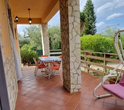a patio with a table and chairs on it at Villa San Lorenzo Sicily in Altavilla Milicia