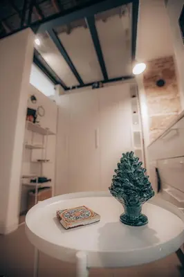 a white table with a plant on top of it at Casa 3D'Oro Palermo in Palermo