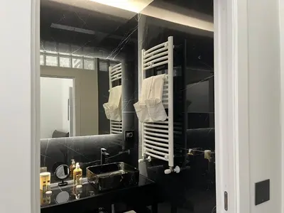 a bathroom with a sink and a mirror at La Dimora di Donna Claudia in Palermo