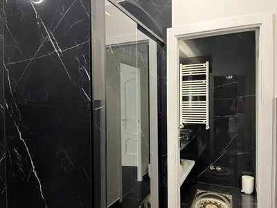 a black bathroom with a mirror and a sink at La Dimora di Donna Claudia in Palermo