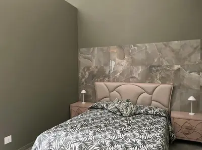 a bedroom with a bed and two night stands with lamps at La Dimora di Donna Claudia in Palermo