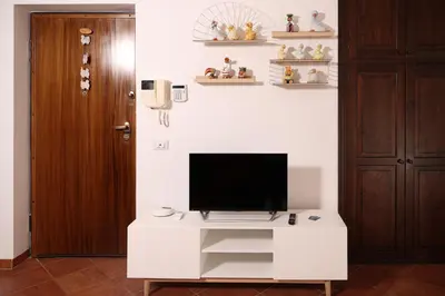a tv on a white stand in a room at Appartamento Rebecca in Palermo