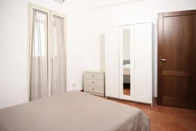 a bedroom with a bed and a dresser and a mirror at Appartamento Rebecca in Palermo