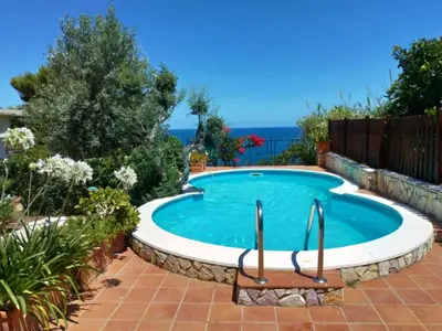 a swimming pool in a garden with a patio at Solemar Sicilia - Villa Corallo in Bagheria