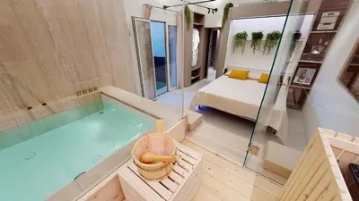 a bathroom with a tub and a bedroom with a bed at Carletta's Aparta-Suite & Spa in Palermo