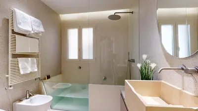a bathroom with a tub and a sink and a mirror at Carletta's Aparta-Suite & Spa in Palermo