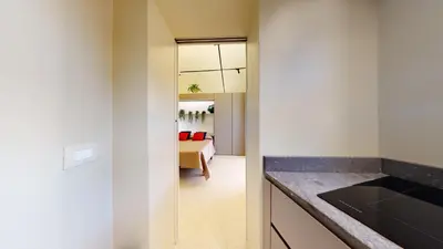 a kitchen with a glass door leading to a bedroom at Carletta's Aparta-Suite & Spa in Palermo