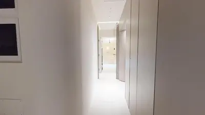 a hallway with white walls and a hallway with mirrors at Carletta's Aparta-Suite & Spa in Palermo