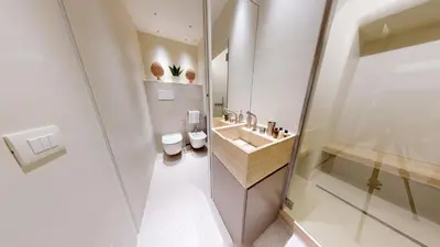 a bathroom with a sink and two toilets at Carletta's Aparta-Suite & Spa in Palermo