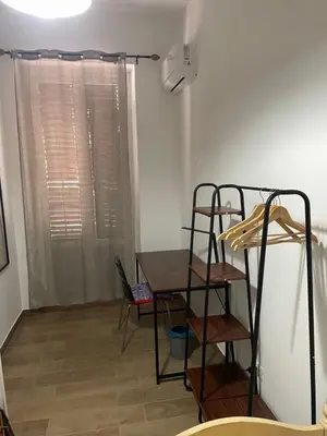 a room with a desk and a table and a shelf at Maison L'amuri in Palermo
