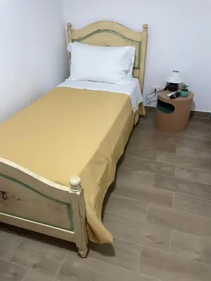 a bed with a yellow bedspread on it in a room at Maison L'amuri in Palermo