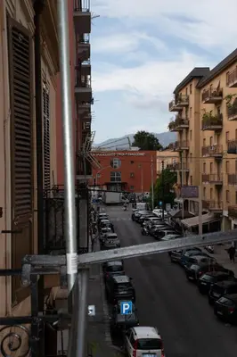 a city street with cars parked in a parking lot at Maison L'amuri in Palermo