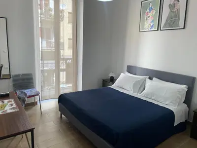 a bedroom with a blue bed with a blue blanket at Maison L'amuri in Palermo